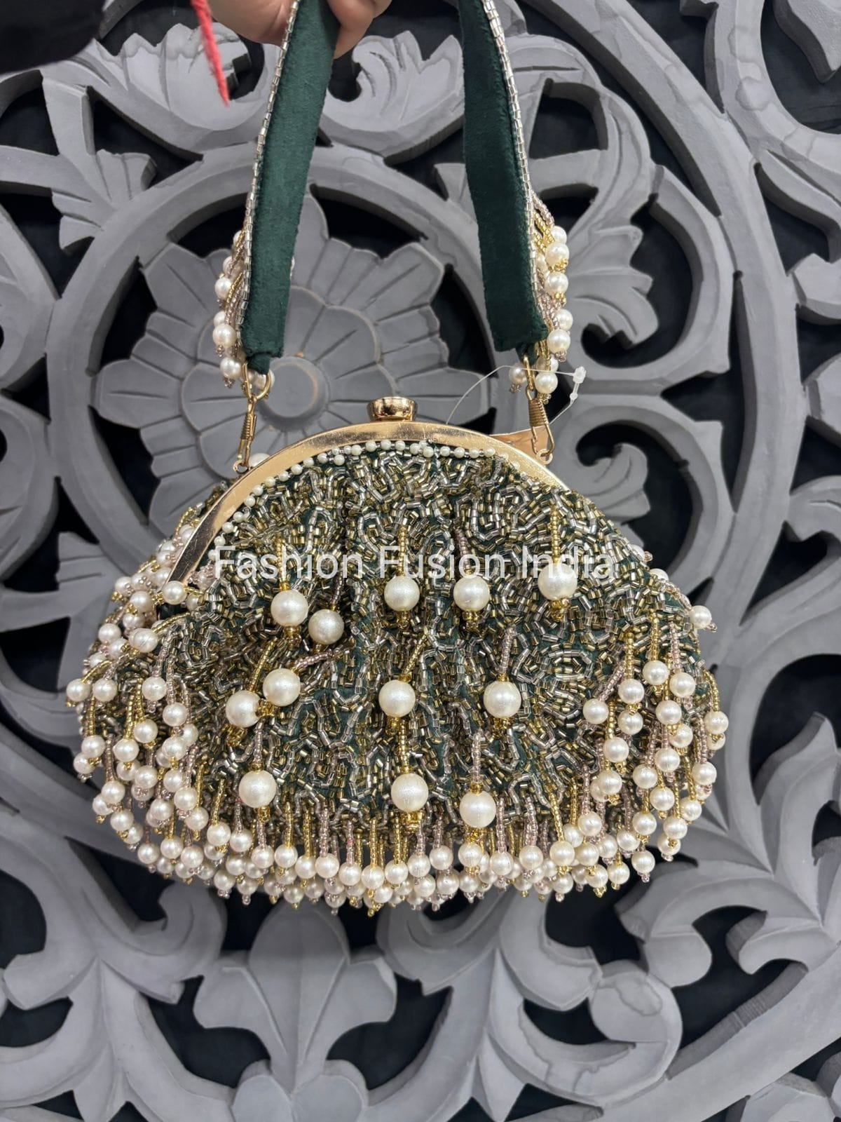Decorative handbag with pearls against a decorative background