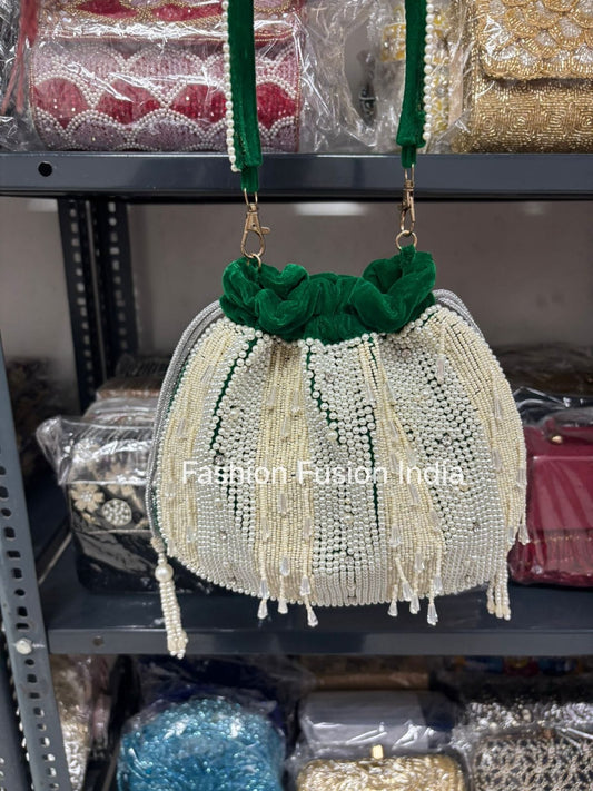 Decorative handbag with green top and beaded details on a shelf with 'Fashion Fusion India' branding.