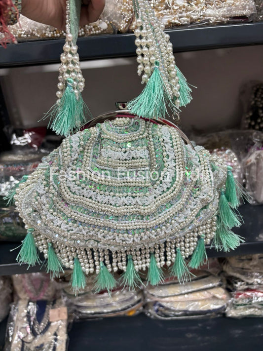 Decorative handbag with green tassels and 'Fashion Fusion India' branding.