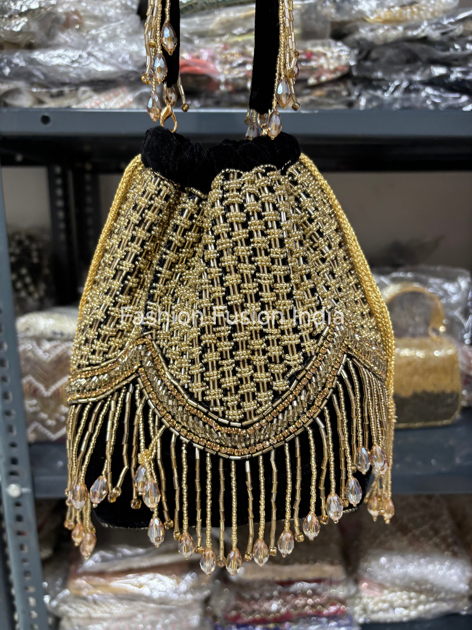 Gold beaded handbag with fringe details on a blurred background