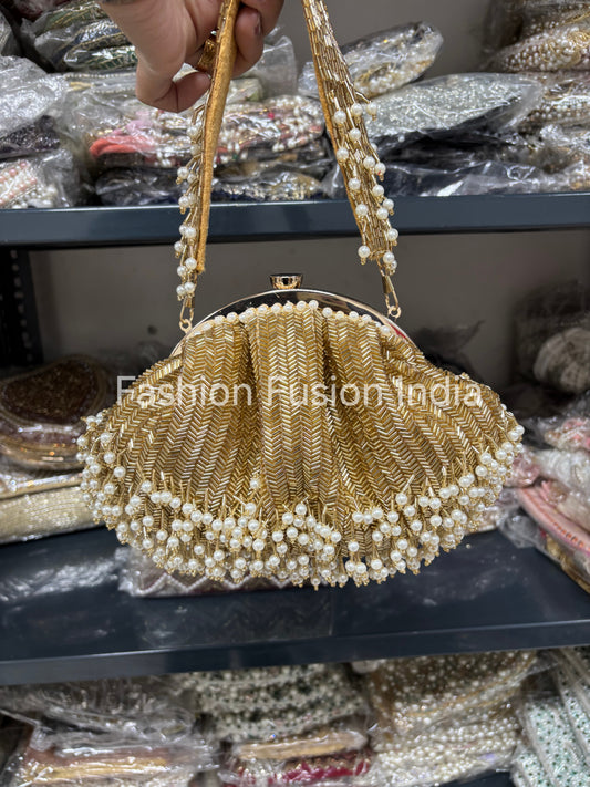 Gold beaded handbag with pearl details held by a hand, with 'Fashion Fusion India' branding.