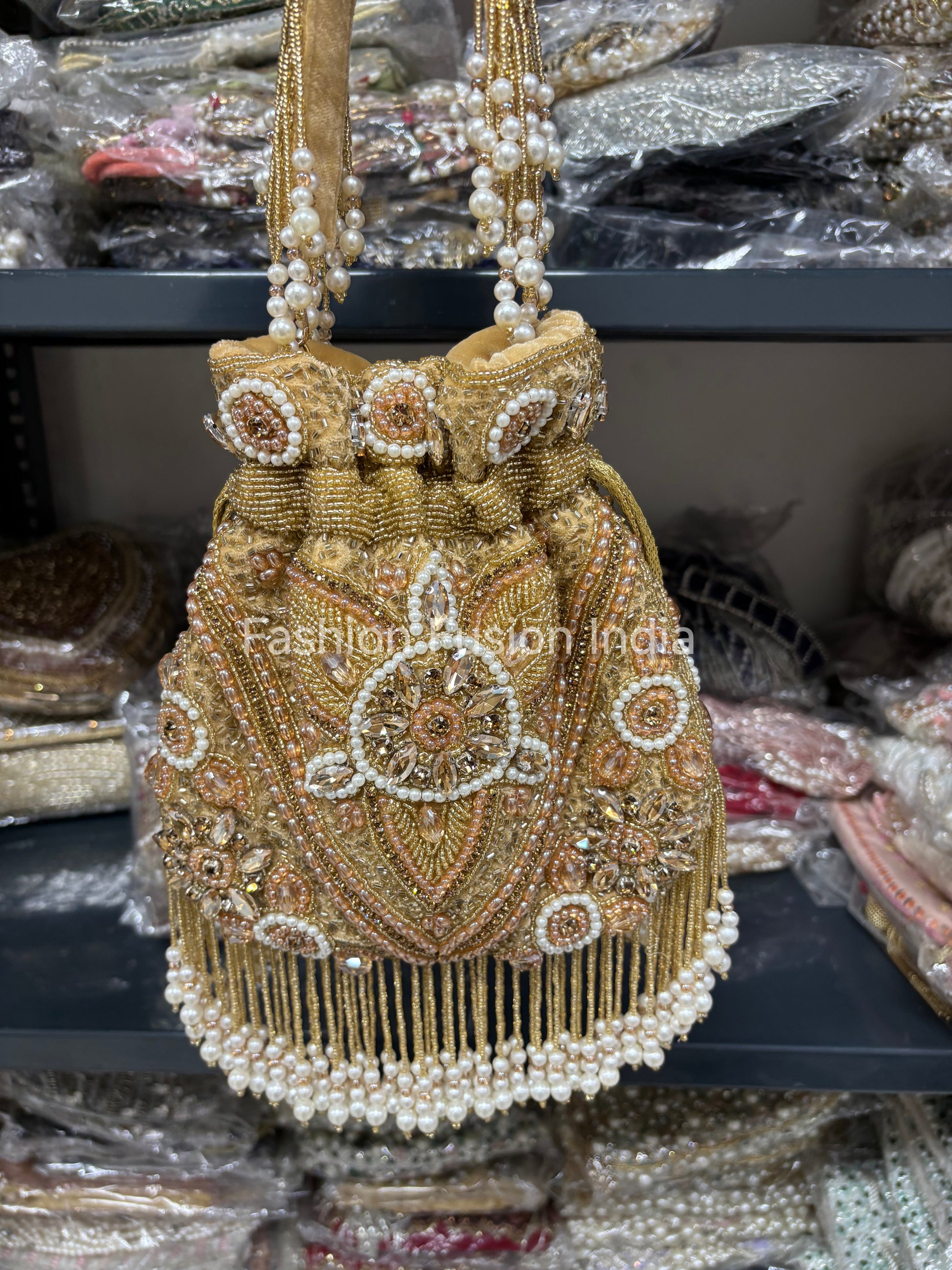 Gold beaded handbag with intricate designs on a blurred background