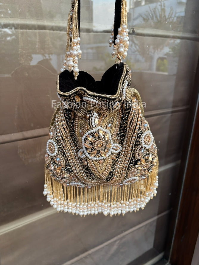Decorative handbag with beading and pearls on a reflective surface