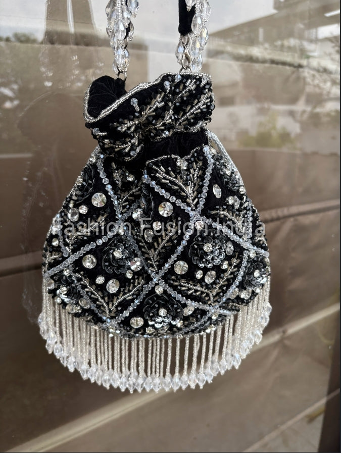 Decorative handbag with beading and embroidery on a reflective surface