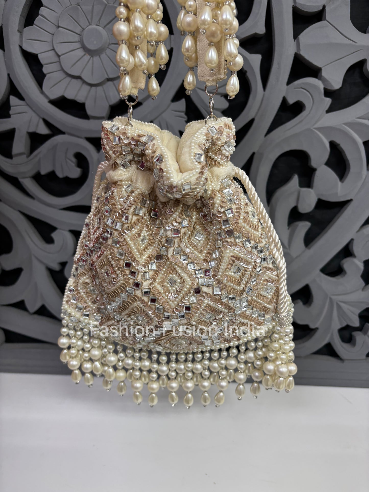 Decorative handbag with pearl embellishments on a decorative background