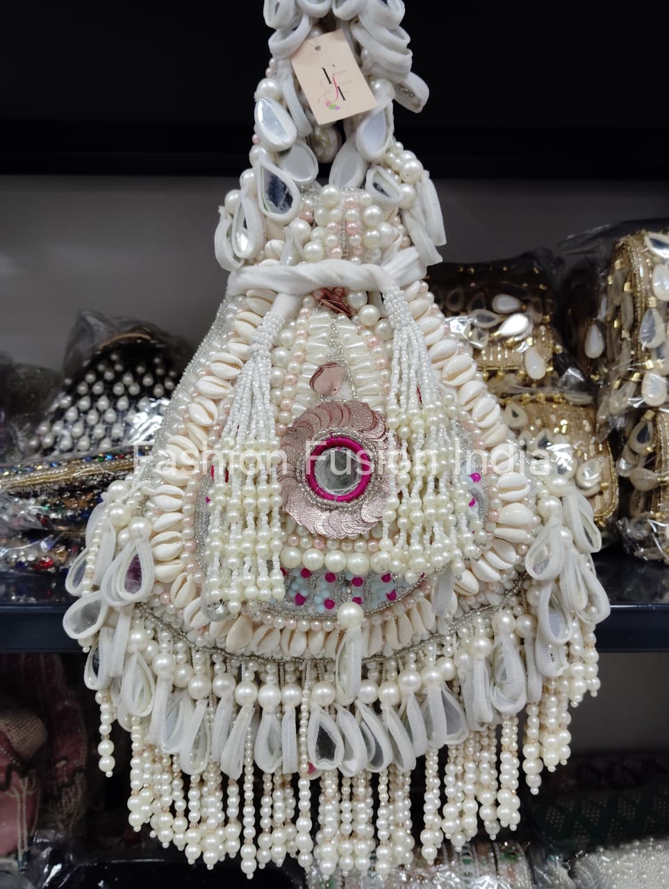 Decorative item with pearls and beads on a dark background