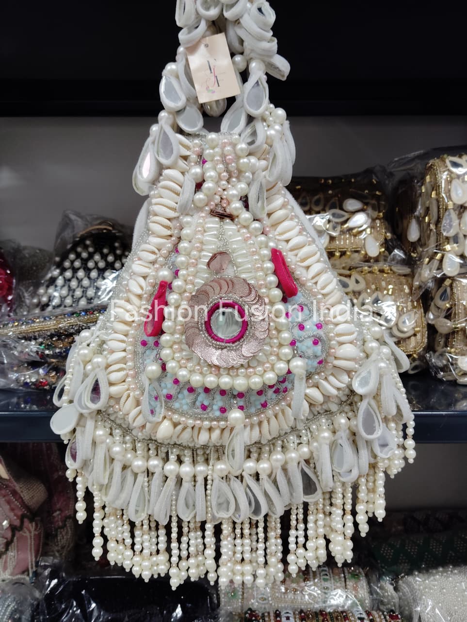 Decorative item made of pearls and beads with 'Fashion Fusion India' branding.