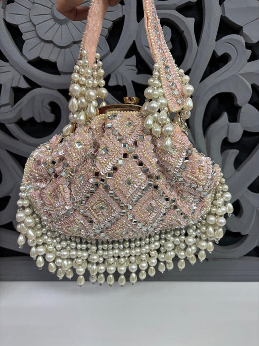 Decorative handbag with pearls and intricate design on a decorative background