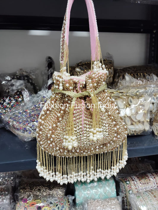 Decorative handbag with pearls and beads on a blurred background