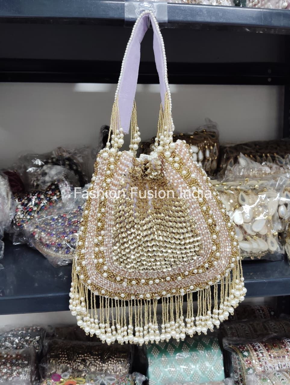 Decorative handbag with pearls and beads on a blurred background