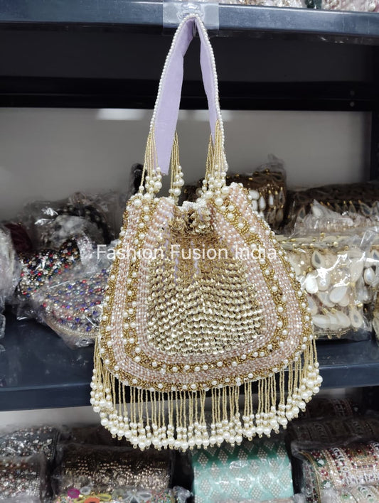 Decorative handbag with pearls and beads on a blurred background