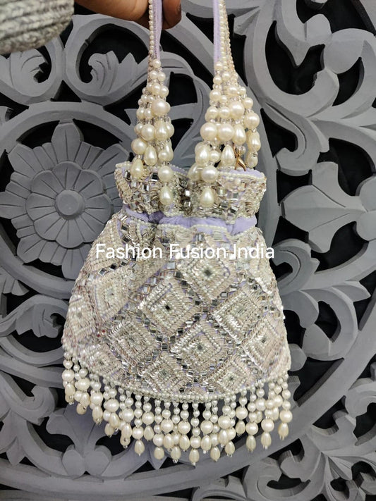 Decorative handbag with pearls against a decorative black and white background