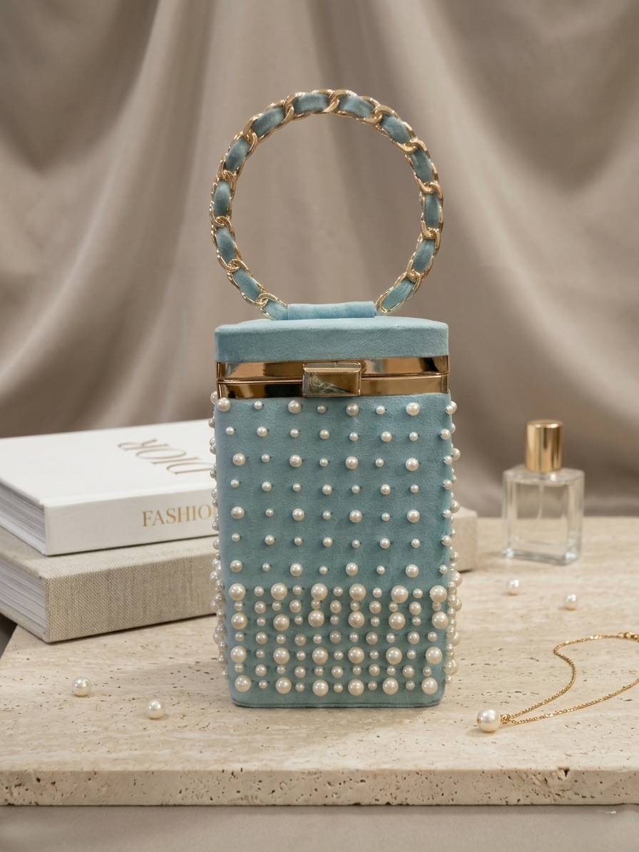 Light blue handbag with pearl embellishments on a neutral background
