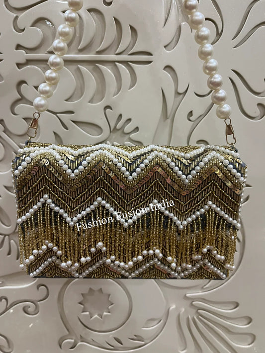 Gold beaded clutch with pearls on a decorative white background