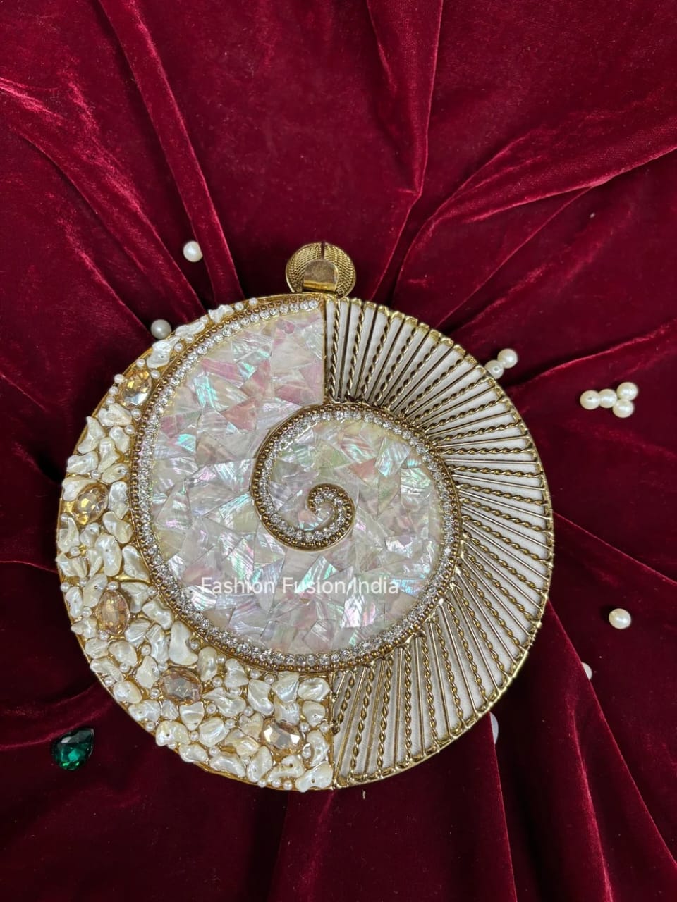 Decorative round object with intricate design on a red fabric background