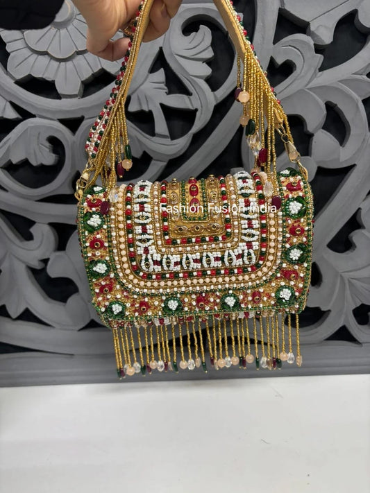 Decorative handbag with beads and tassels on a white surface with a decorative black and white background.