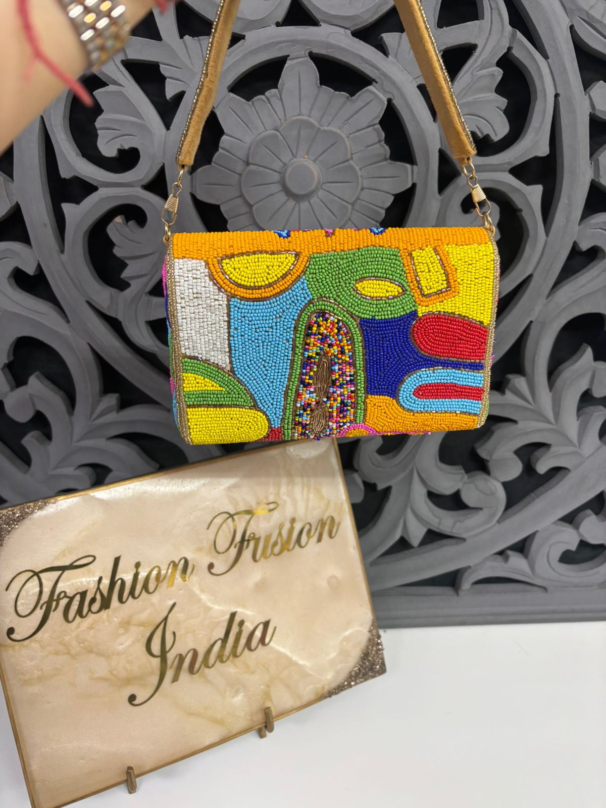 Colorful beaded handbag with a decorative pattern on a white surface, featuring 'Fashion Fusion India' packaging.