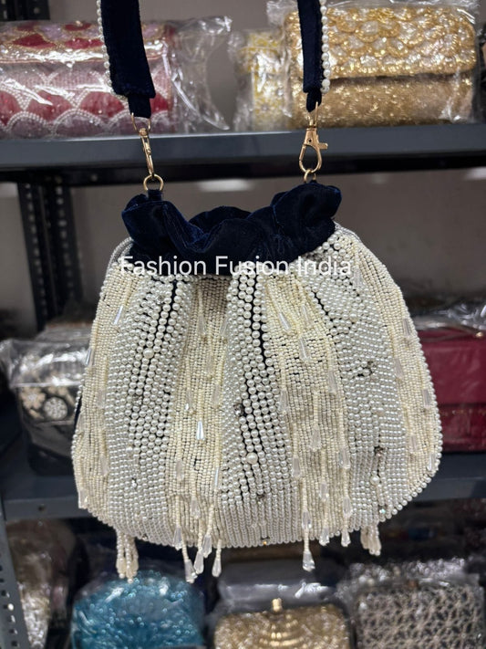 Beaded handbag with tassels on a shelf with 'Fashion Fusion India' branding.