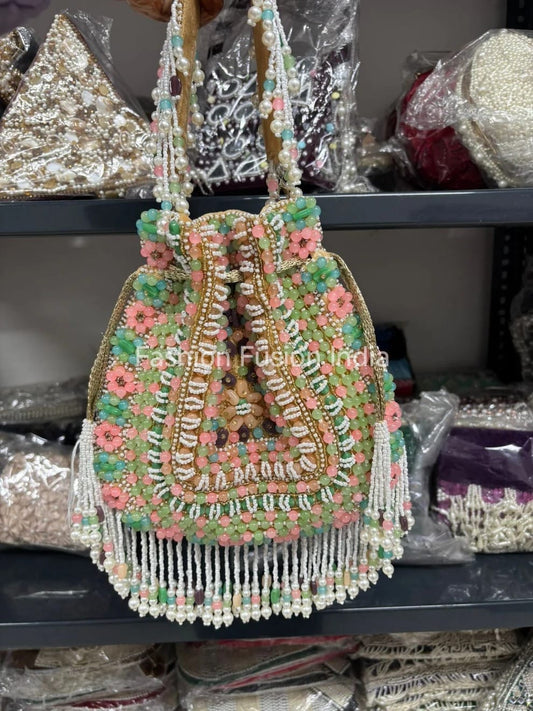 Decorative beaded handbag with floral patterns on a shelf with similar items.
