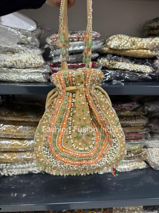 Decorative handbag with beads and sequins held above a shelf with similar bags.