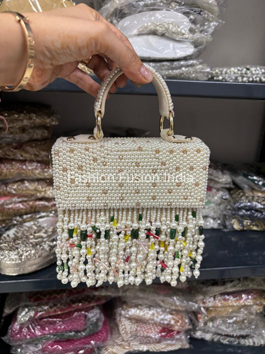 Handheld beaded handbag with colorful tassels in a store setting