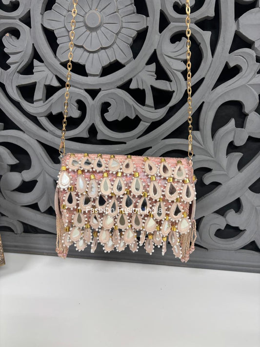 Decorative handbag with intricate designs and embellishments against a decorative wall.