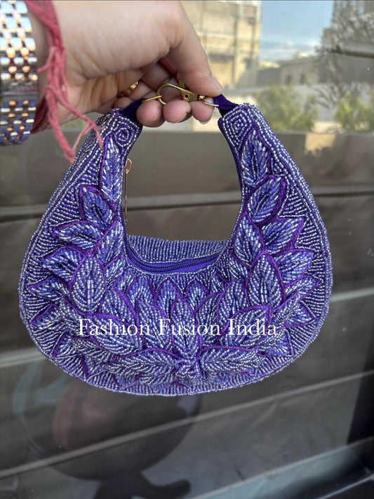 Purple embroidered fabric piece held by a hand with a blurred outdoor background