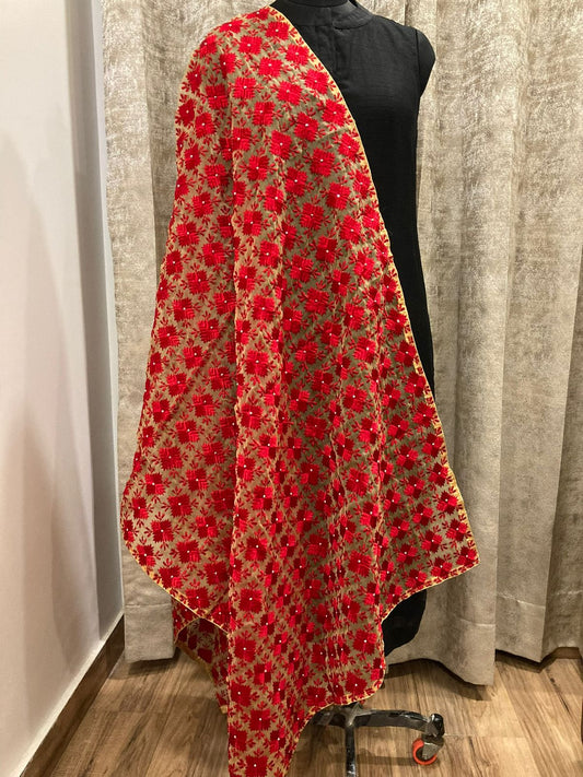 Red floral patterned fabric draped over a mannequin against a neutral background