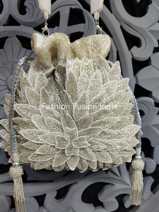 Decorative handbag with floral design and tassels on a patterned background