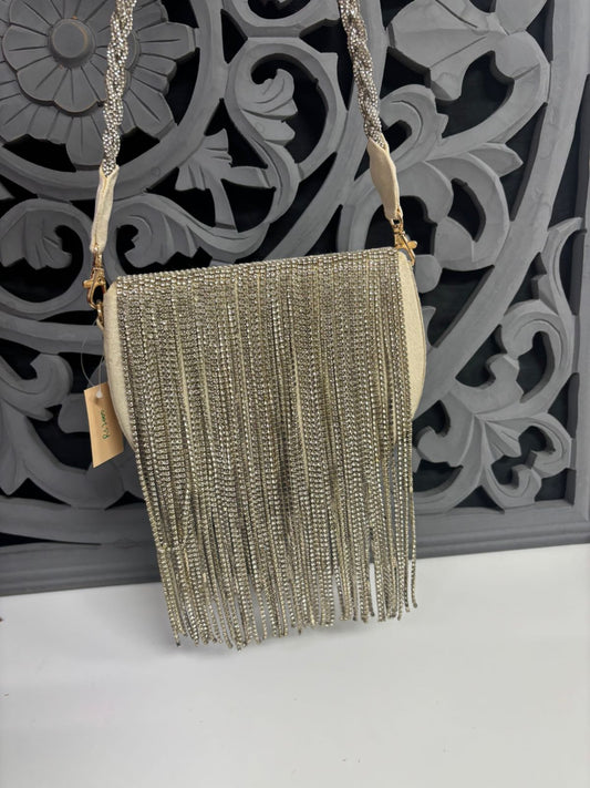 Beaded handbag with fringe on a decorative wall background