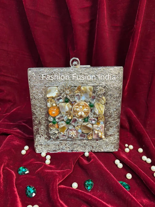 Decorative clutch with gemstones on a red fabric background, branded 'Fashion Fusion India'.