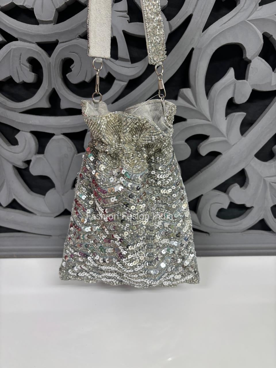Silver sequin handbag with a decorative background
