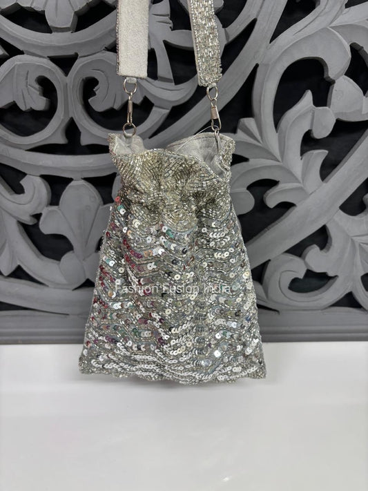 Silver sequin handbag with a decorative background