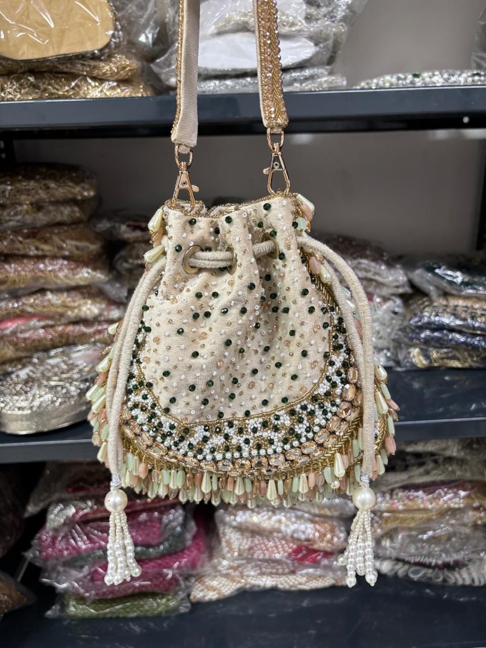 Decorative handbag with beads and tassels on a shelf with packaged items.
