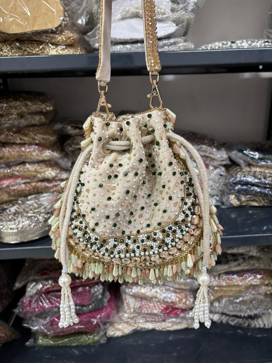 Decorative handbag with beads and tassels on a shelf with packaged items.