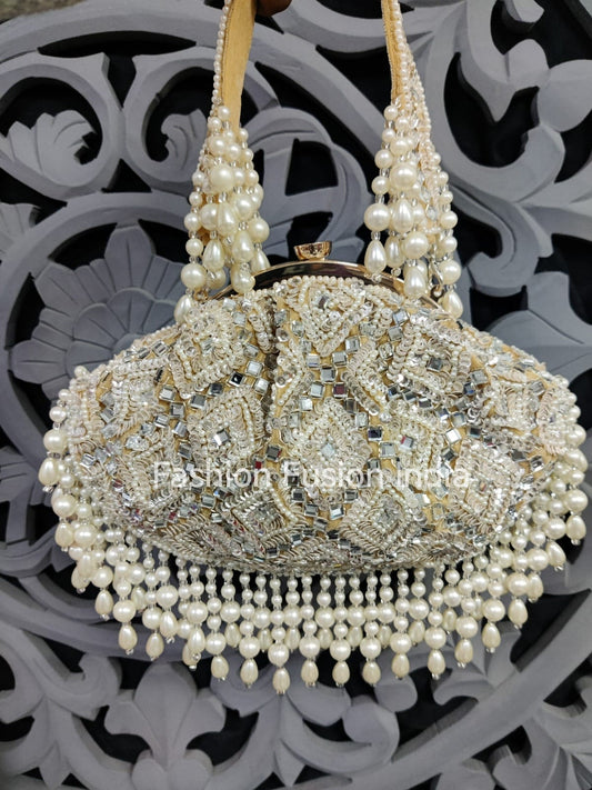 Decorative handbag with pearl handle and embellishments on a decorative background