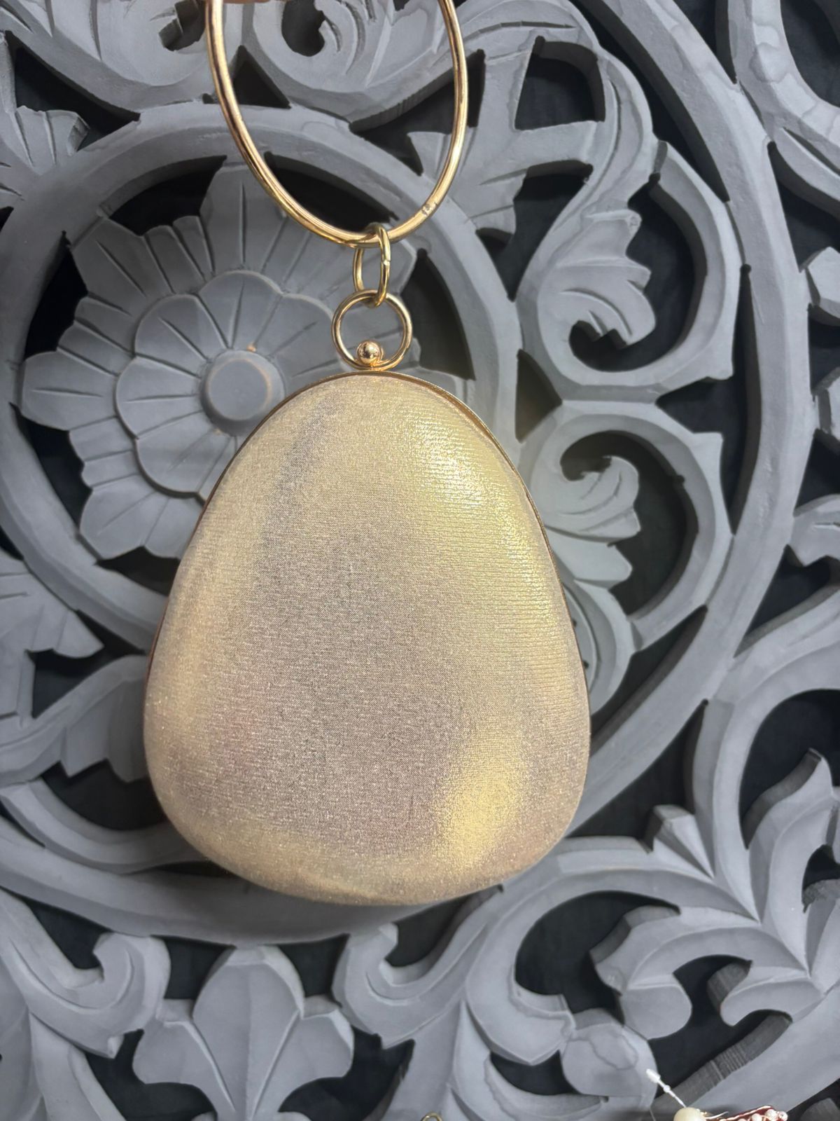 Gold pendant on a decorative background