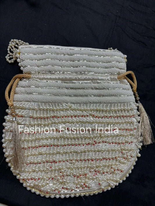Beaded handbag with tassels on a black background, branded 'Fashion Fusion India'.