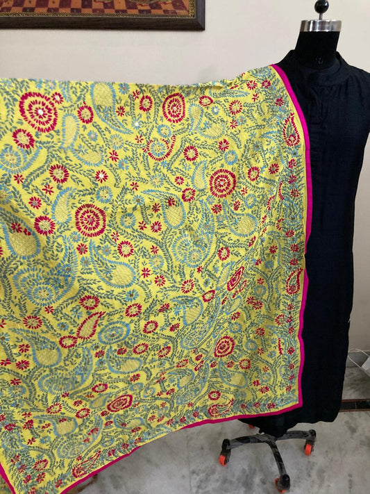 Colorful floral patterned fabric draped over a mannequin against a neutral background