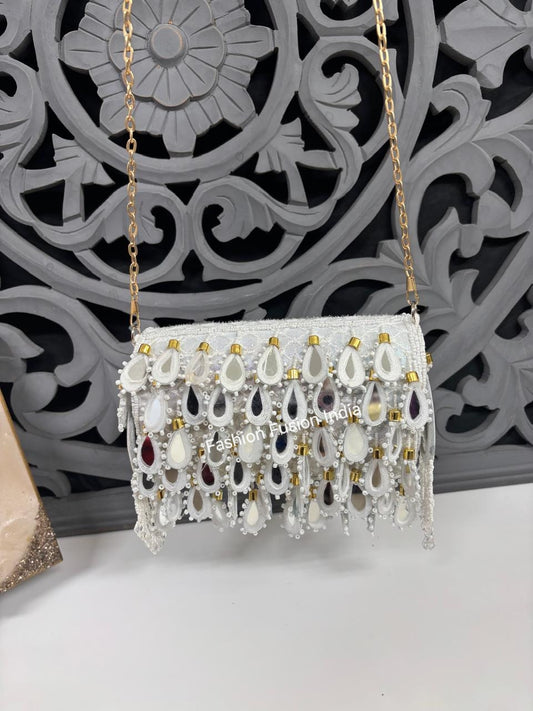 Decorative handbag with beads and chain strap on a decorative wall background
