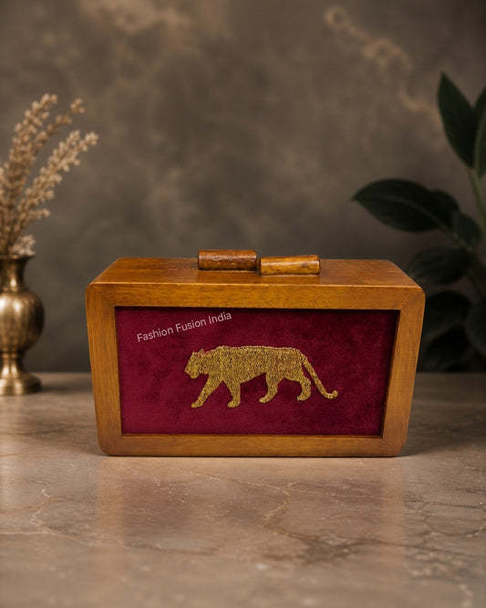 Wooden clutch bag with tiger embroidery on maroon velvet.